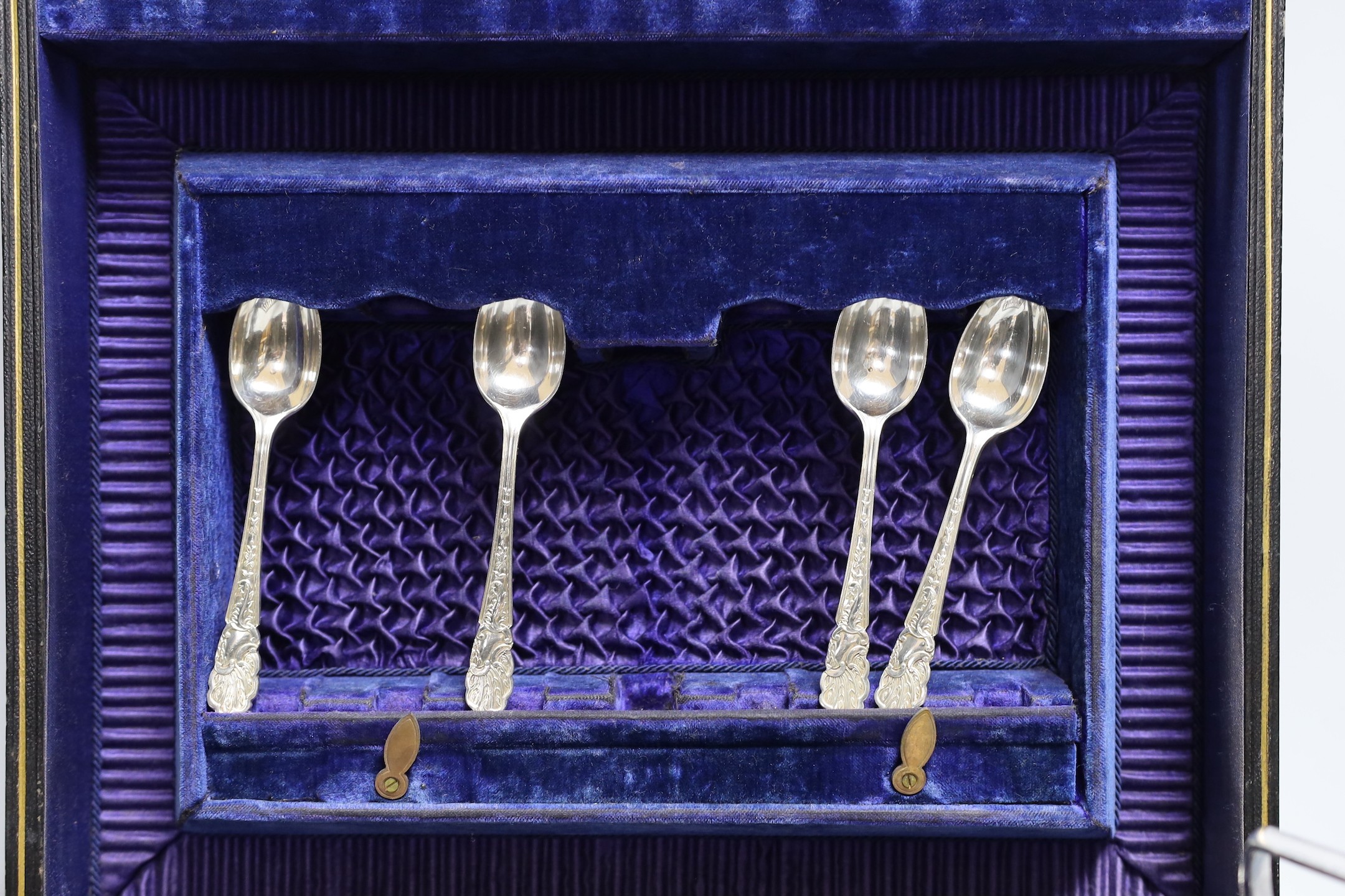 Six pairs of silver plated and engraved dessert knives and forks, with server, mother of pearl handles and six teaspoons (cased) and a silver plated cream jug and sugar bowl.